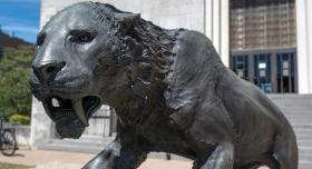 An image of the saber tooth cat statue in front of the museum 