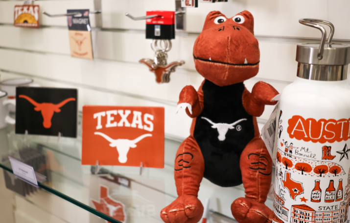 Stuffed dinosaur and austin themed gear at the museum store