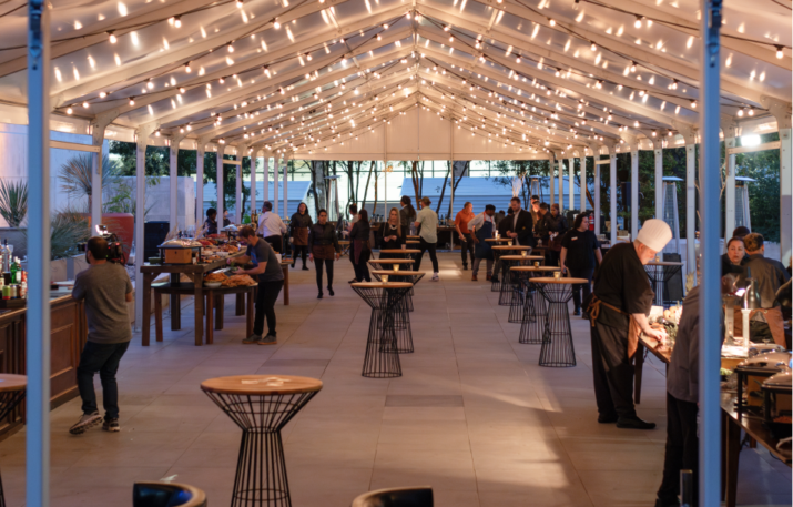 Tent in plaza lit up for outdoor reception