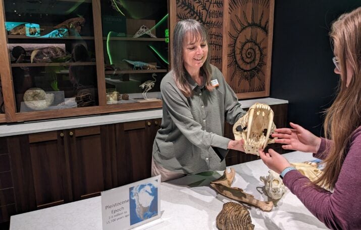 paleontologist showing fossil