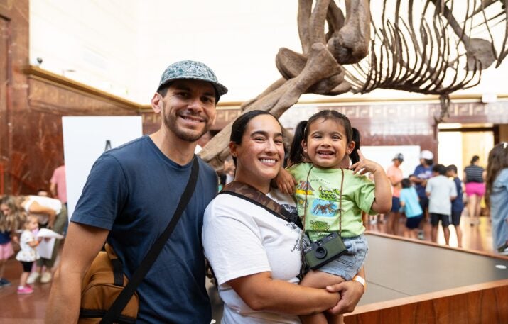 Family in front of tyrannosaur skeleton
