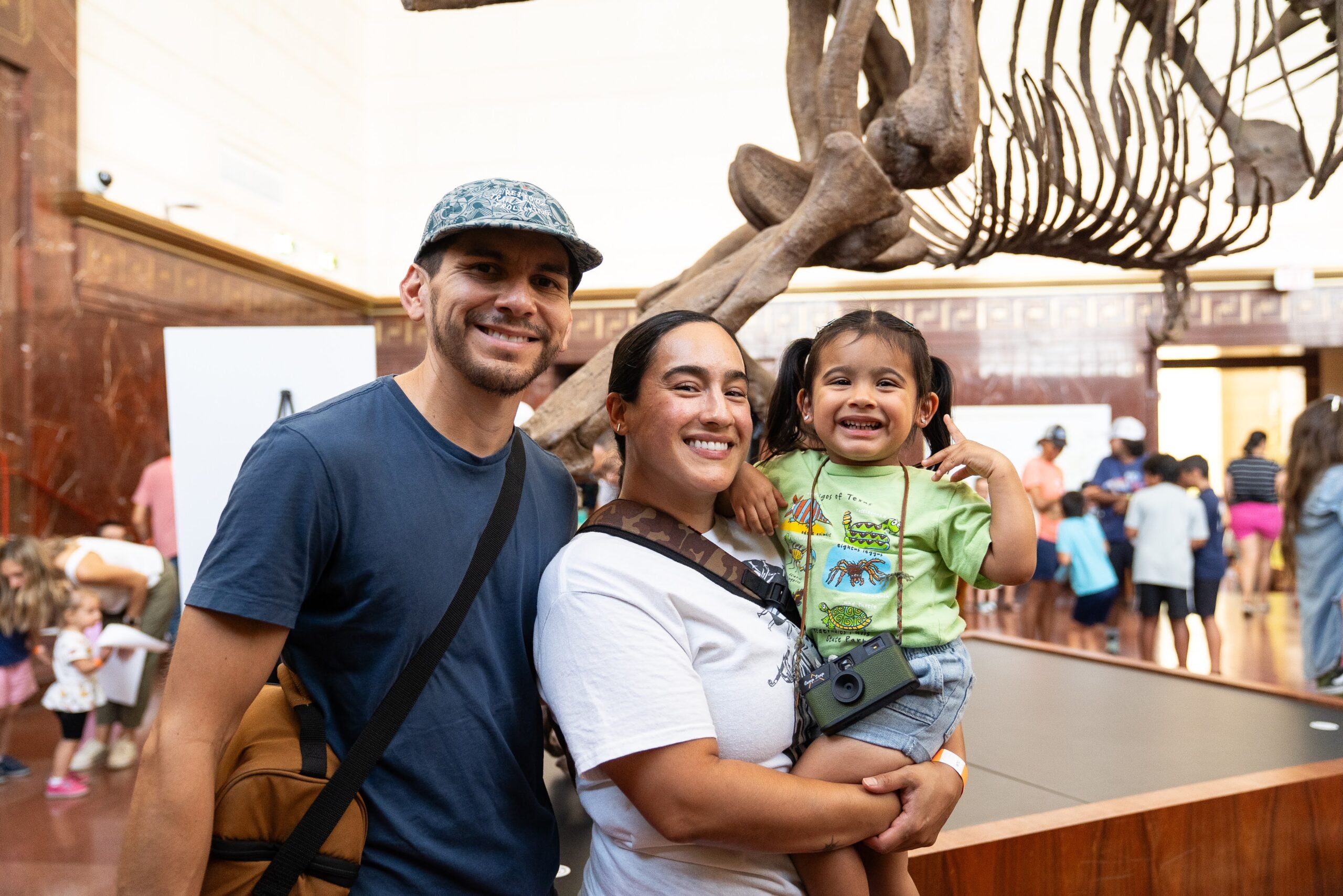 Family in front of tyrannosaur skeleton