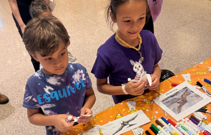 two children at table with pterosaur activities