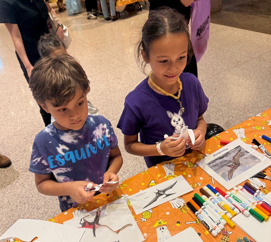 two children at table with pterosaur activities